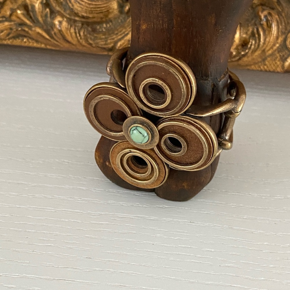 womens adjustable artsy brushed gold costume bracelet with turquoise center.